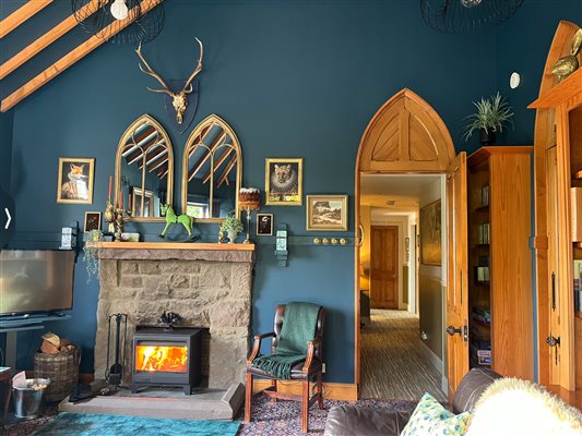 The lounge with log burner with a view down the corridor